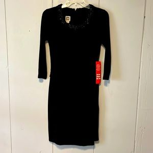 Long sleeve black “faux” wrap dress.